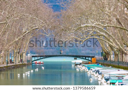 Famous pedestrian footbridge Bridge of Loves or Pont des Amours over channel of Vasse near lake of Annecy, Venice of the Alps, France