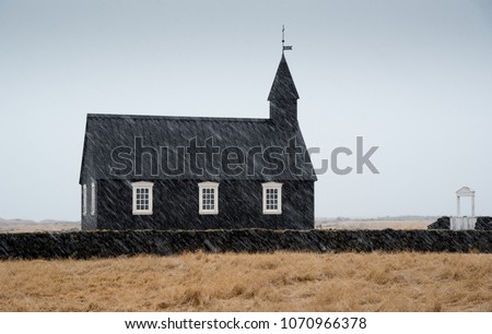 Famous picturesque black church of Budir at Snaefellsnes peninsula region in Iceland during a heavy snowy weather