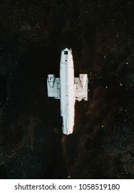 The famous plane wreck in Iceland on a black sand beach, directly from above, shot from a drone