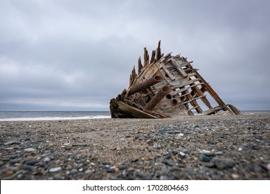 The famous and popular Pesuta Shipwreck on a cloudy day giving it a dark and dramatic effect. The =wreck is located on the East Beach in Naikoon Provincial Park, Haida Gwaii British Columbia, Canada