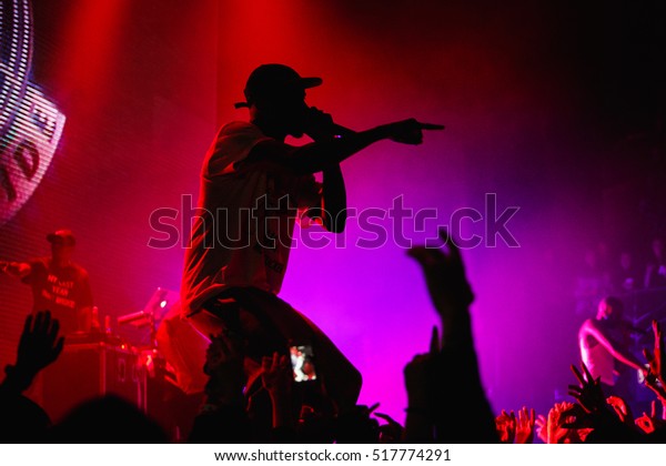Famous rap band Asap Mob performing live\
hip hop music show on nightclub stage. Silhouette of rapping singer\
with microphone on scene. Rapper concert in crowded music hall\
EUROPE-15 NOVEMBER,2016