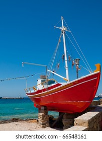 The famous red boat-restaurant with an octopus on the background of the sea on the island of Mykonos.