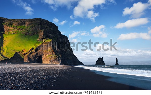 Famous\
Reynisdrangar rock formations at black Reynisfjara Beach. Coast of\
the Atlantic ocean near Vik, southern\
Iceland.