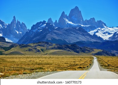 Famous rock Fitz Roy peaks in the Andes. Magnificent panorama of snow-capped mountains in Patagonia. To mountains leads the asphalt road