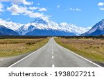 Famous shot of the snow-covered Southern Alps with the straight road leading directly towards Aoraki Mount Cook. South Island, New Zealand