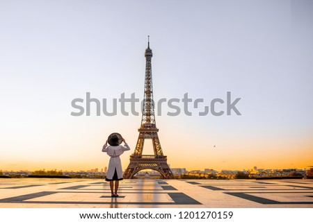 Famous square with great view on the Eiffel tower and woman standing back enjoying the view in Paris