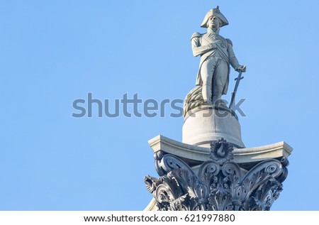 The famous statue of Admiral Nelson on Trafalgar Square in London, UK, on blue clear sky