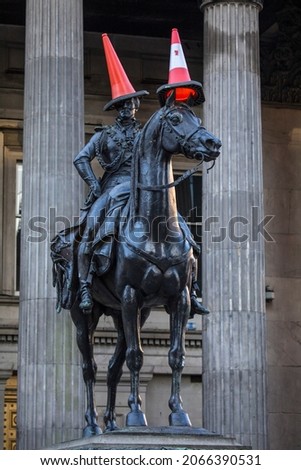 The famous statue of the Duke of Wellington, located on Royal Exchange Square in Glasgow, Scotland.  The statue is typically capped with a traffic cone which has become a tradition.  