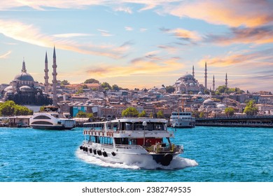Famous Suleymaniye and Rustem Pasha Mosques and the cruise boat on the Bosphorus, popular place of Istanbul, Turkey