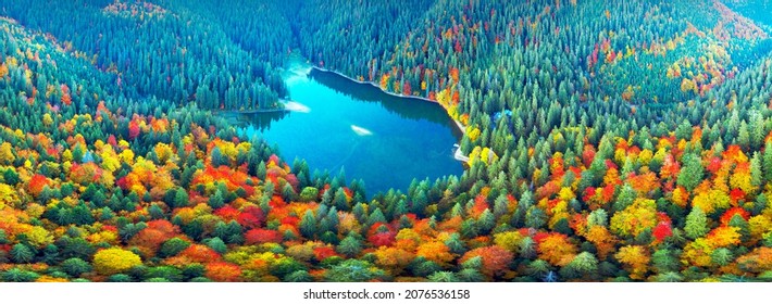 The famous Synevyr lake, a tourist attraction, in the Carpathians, Ukraine, autumn beech and coniferous forest, beautiful mountain landscape. Aerial view drone copter - Shutterstock ID 2076536158
