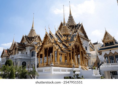 Famous Thailand temple, the Grand Palace in Bangkok, with traditional ornate Thai architecture. The palace has golden spires and decorative rooftop. - Powered by Shutterstock