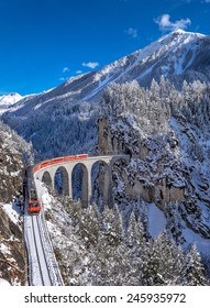 Famous Train With Jungfrau Mountain On Sunny Day