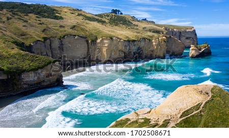 Famous Tunnel beach in New Zealand, DUNEDIN, NEW ZEALAND Popular tourist attraction in Dunedin, South island of New Zealand, amazing coast line from above, Cliff formations at Tunnel Beach