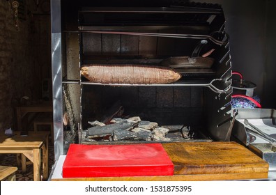 Famous Turkish Food Kokorech Being Prepared On The Bbq. Turkish Kokorec Made With Sheep Bowel Cooked In Wood Fired Oven.