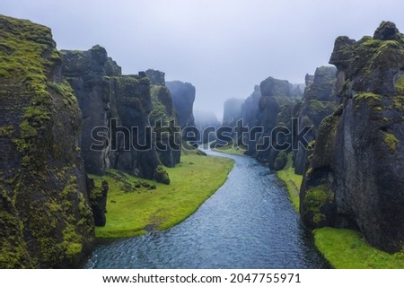 The famous and unique Fjadrargljufur valley in Iceland on a rainy day. Mossy cliffs and mountain river. Point of interest for tourists coming to visit Iceland