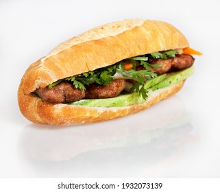 Famous Vietnamese food is banh mi thit, popular street food from bread stuffed with raw material: grilled pork and fresh herbs as scallions, coriander, carrot, cucumber, chilli. On White
