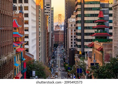 Famous view of California Street near China Town and the Financial District, with Chinese pagoda towers and the Bay Bridge at sunset in San Francisco