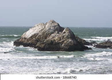 A famous view in the out skirts of Sanfransico, containing rocks an the ocean.