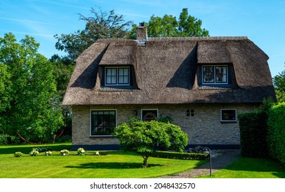 Famous village is know as "Venice of the North" Giethoorn, Netherlands. Village with canals and rustic thatched roof houses. The beautiful houses and gardening.