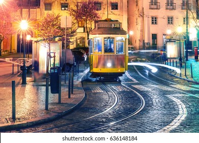 Famous vintage yellow 28 tram of of Alfama, in the oldest district of the Old Town, at night, Lisbon, Portugal.