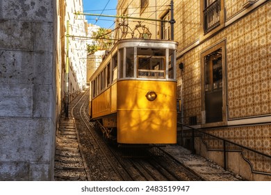 Famous vintage yellow tram  in the narrow streets of Alfama district in Lisbon, Portugal - symbol of Lisbon, famous popular travel destination and tourist attraction - Powered by Shutterstock