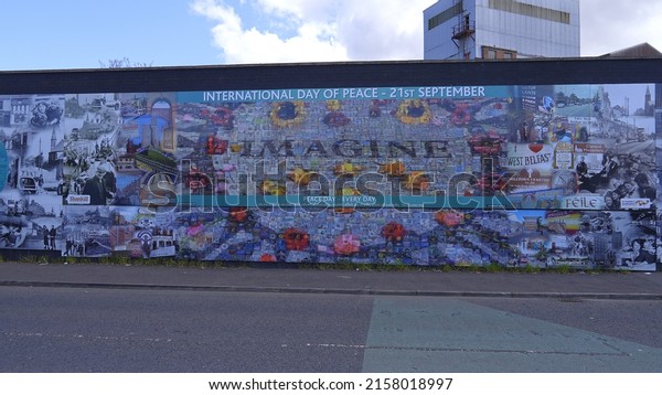 The famous Wall\
Murals of Belfast on the houses and Peace Wall - BELFAST, UNITED\
KINGDOM - APRIL 25, 2022