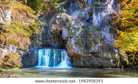the famous waterfall atysh flowing from a karst funnel in the Ural mountains of Bashkortostan on an autumn sunny day