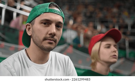 Fan man portrait football sport stadium. Handsome guy look camera soccer tribune. Serious male face close up. Person gaze stare into soul. Cap people view game match. Fans watch win play stands arena. - Powered by Shutterstock