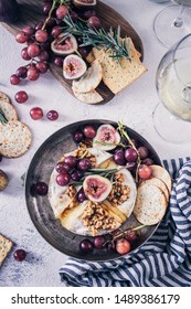 Fancy Baked Brie Cheese Platter With Honey And Walnuts, Fresh Rosemary. Red Grapes, Figs And White Wine