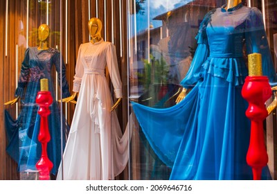 Fancy clothing on mannequins in a store in Arabic shops. Display of a clothing store, bright and fashionable window of modern fashion. Beautiful clothing in a luxury store window. Sale for people - Powered by Shutterstock