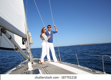 Fancy Couple Enjoying Sailing On A Beautiful Sailboat