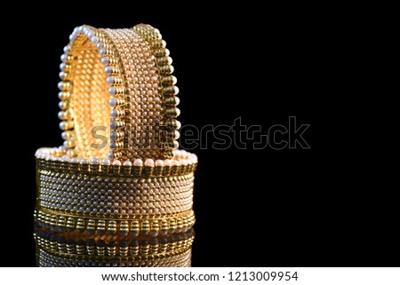 Fancy designer Golden bracelet for woman fashion/ Gold plated jewelry closeup image on black background   