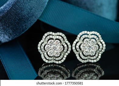 Fancy Diamonds Earrings With Blue Ribbon On Black Isolated