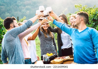 Fancy Friends Enjoying Harvest Time Together Drinking At Farm House Country Side - Beverage Life Style Concept With Young People Toasting Red Wine Glasses At Italian Vineyard - Bright Vivid Filter