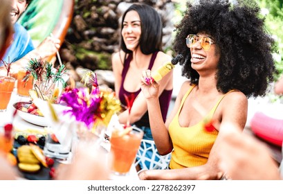 Fancy friends group eating fruit skewers at pool side cocktail party - Life style vacation concept with young men and women having fun together on summer day at luxury location - Bright vivid filter - Powered by Shutterstock