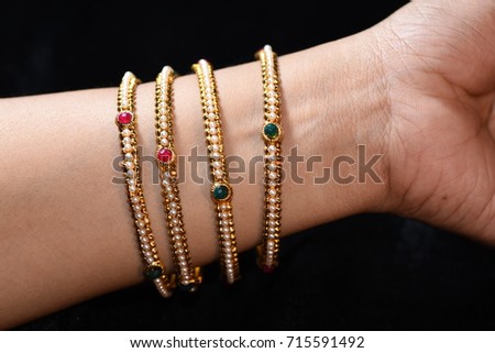fancy golden bracelet bangles on woman wrist