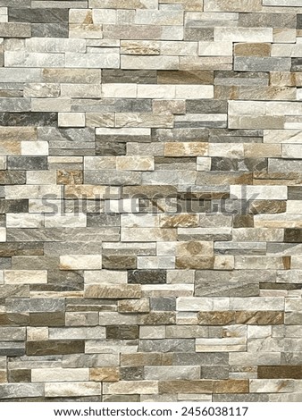 A fancy interior stone wall pattern in brown and grey. 