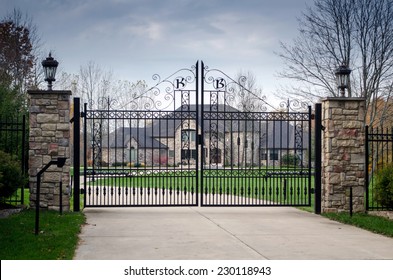 fancy large mansion behind a locked gate