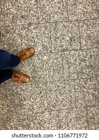 Fancy Men's Dress Shoes And Jeans On Concrete Tile Floor In Subway