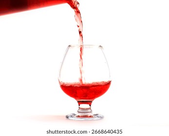fancy patterns of a jet of red wine when poured into a glass