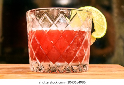 Fancy Red Cocktail In Retro Prohibition Era Glass On Wood Table