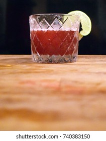 Fancy Red Cocktail In Retro Prohibition Era Glass On Wood Table