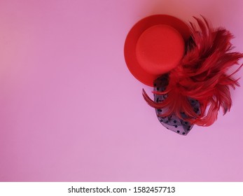 A Fancy Red Hat On Pink Board