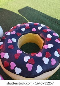 A Fancy Seats, Donut-shaped Design, Decorated With Small Hearts, Placed At The Entrance Of A Restaurant.


