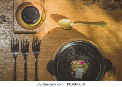 Fancy Silverware, Crockery, Plates And Other Stuff On A Table, With Some Sort Of A Fancy Food, Looking From Above.