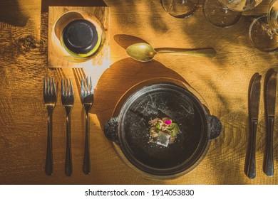 Fancy Silverware, Crockery, Plates And Other Stuff On A Table, With Some Sort Of A Fancy Food, Looking From Above.