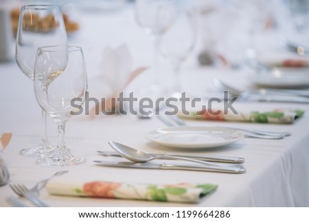 fancy table set for a wedding dinner, decorated chairs