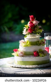 A Fancy Wedding Cake Decorated With Flowers