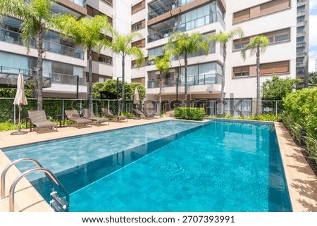 A fancy and wide condominium pool 