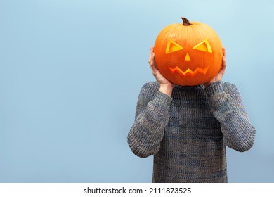 fanny guy with pumpkin  instead of head isolated on blue background, scary jack o lantern pumpkin for halloween